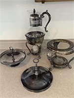 Silver serving dishes and candle holder