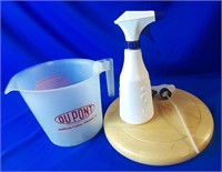 Measuring Cup, Spray Bottle And Wood Trivet