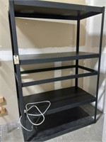 Black metal shelves with surge protector