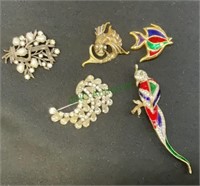 Lot of five brooches - one with red white and blue