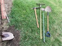 Various tools including a Pick Axe, Rake, hoe,