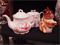 Three china teapots: one in the form