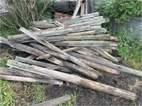Pile of Assort Size Fence Used Posts