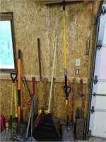 Yard Tools Axes and Rail Next to Garage Door