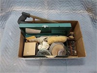 assortment of hand saws and sanding discs