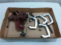 assortment of clamps and bench vise