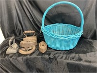 WOVEN BASKET FILLED WITH ANTIQUE SAD IRONS