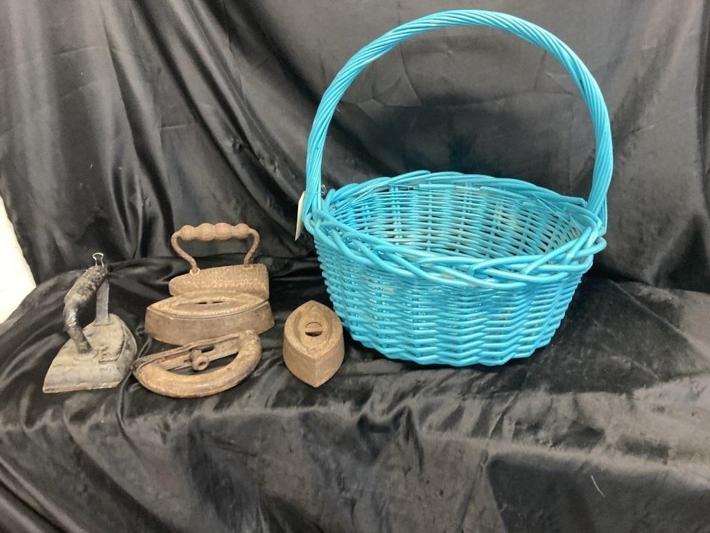 WOVEN BASKET FILLED WITH ANTIQUE SAD IRONS