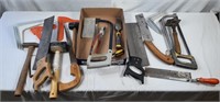 Collection of hand saws, push sticks, and other