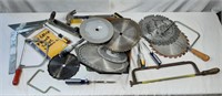 Assortment of saw blades, hammer, and hand tools