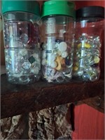 3 jars of decorative glass beads and some