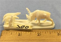 3" carved ivory battle scene with 3 wolves and a c