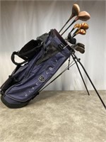 Nike golf bag with assorted old wood head golf