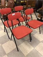 Four Red and Black Stackable Chairs