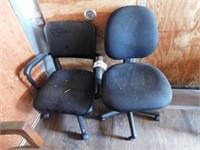 Two black rolling office chairs