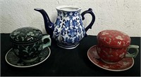 Small ceramic teapot and two teacups with