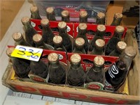 23 OLD COKE BOTTLES WITH PAPER HOLDERS AND