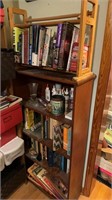 Five shelf bookcase with books, and some art