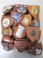 Fifty World Police cap badge timber plaques