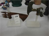 Two bronze axes on stand.