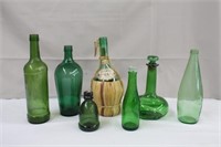 Collection of green bottles including 1958