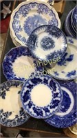 Assorted blue white plates. Some flow blue, wall