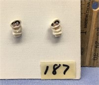 Fabulously done pair of ivory stud earrings of a m
