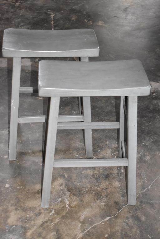 Two Gray Wood Saddle Stools