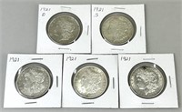 Five 1921 Morgan Silver Dollars.