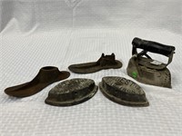 3 sad irons and 2 shoe forms.