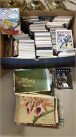 Shoebox of football cards with a stack of old