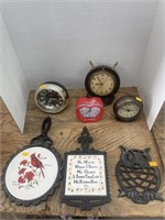 4 clocks , vintage cast iron trivets