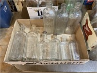 case of embossed clear bottles with different