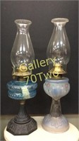 Pair of antique oil lamps – one has a cast iron
