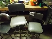 Two gray padded  swivel shop stools, 24" & 32"T