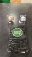 Golf balls in original box with a yardage guide