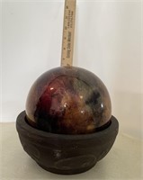 Brown resin ball in clay pot décor