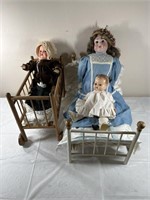 4 old dolls and doll bed