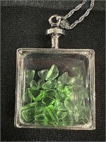 1" square glass container filled with green glass