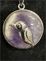 Circular  amethyst pendant with silver bird on