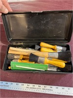 Plastic toolbox, full of brushes