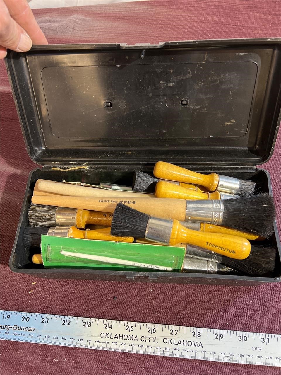 Plastic toolbox, full of brushes