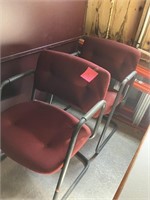 two red fabric metal arm chairs