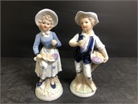 2 Porcelain figurines standing 7.5" tall.