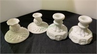 Two pairs of milk glass candle sticks - one with a