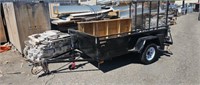 Small black utility trailer with two styles of