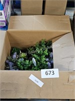 box of small artificial potted plants