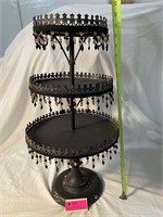 Three tiered black metal stand