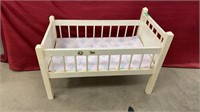 Wooden crib with crib sheets. Measures 33x22.5x19
