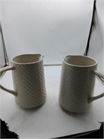 2 white pitchers